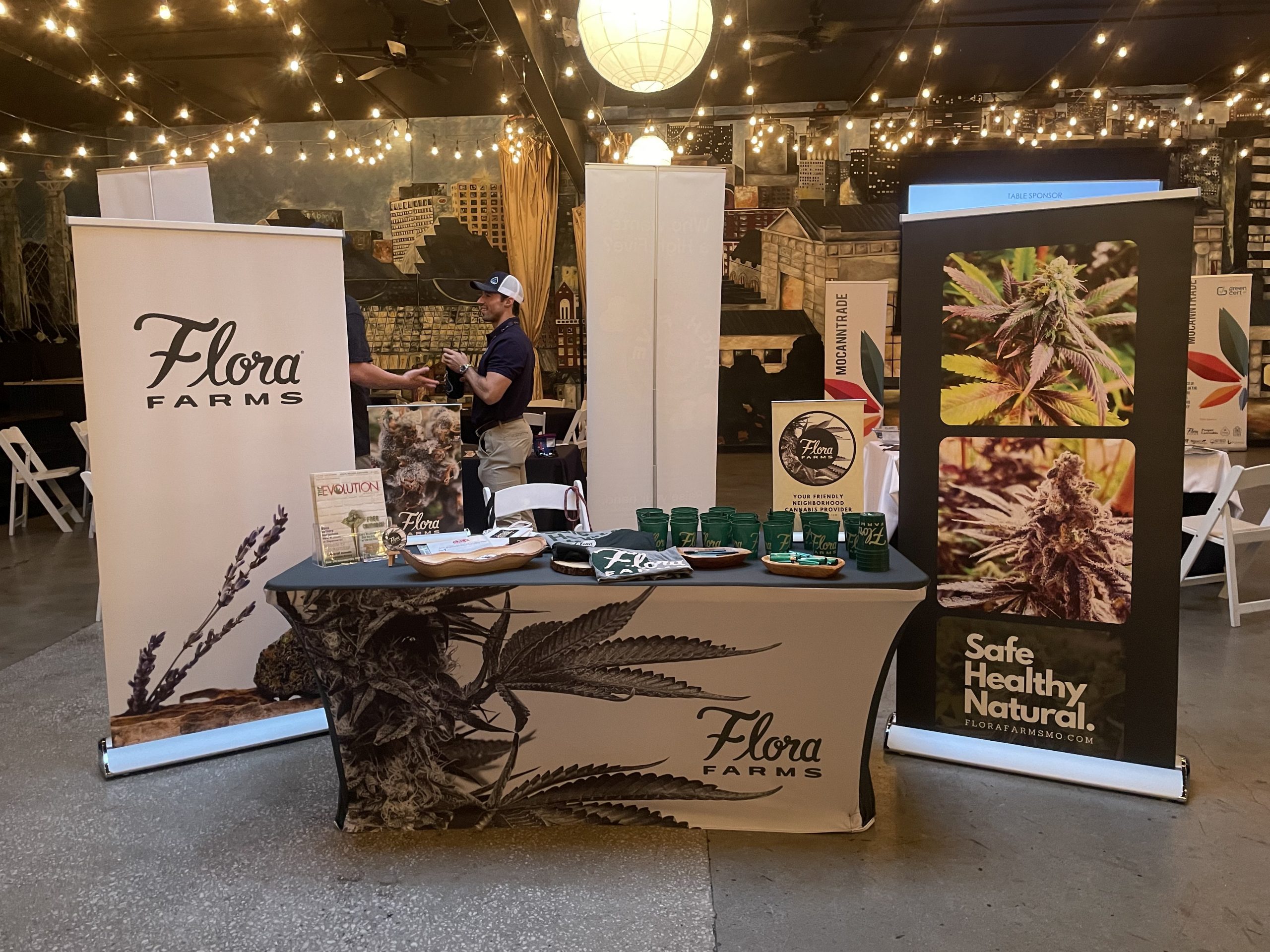 Flora Farms table displayed with merch at MoCannTrade meetup