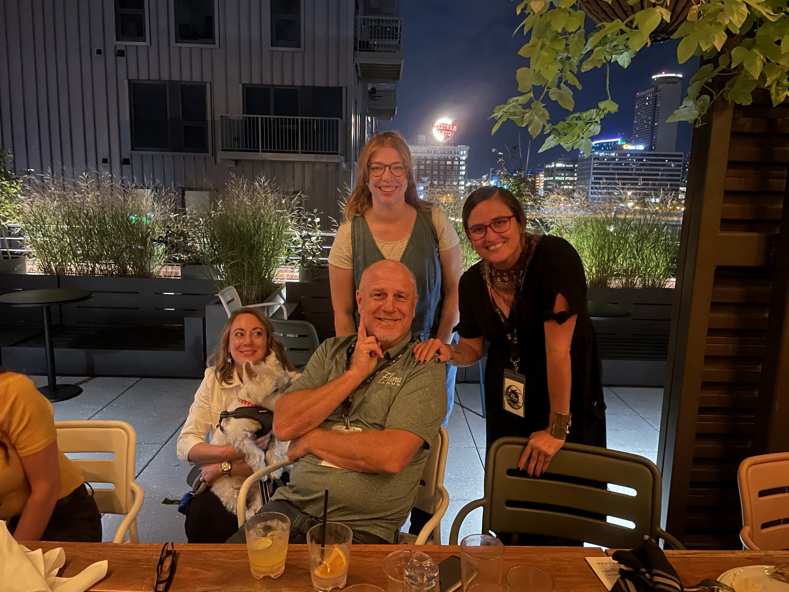 Mary Kate Black, Charlie (West Highland Terrier), Emily Cross, Karla Deel, and Mark Hendren pose together at impromptu after meetup at Percheron Rooftop Bar hosted by Flora Farms