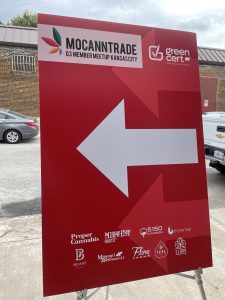 Sign with arrow and logos at MoCannTrade meetup
